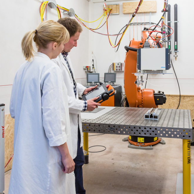 FTI Förderung von Forschungs-, Technologie- und Innovationsprojekten (im Bild: Forscher am Industrieroboter)